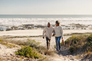 Senior couple relaxing on a beach, enjoying retirement planning from Le’Risque Africa